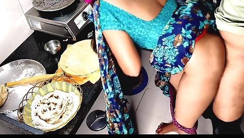 Indian desi uncle is at work and his wife is working in the kitchen