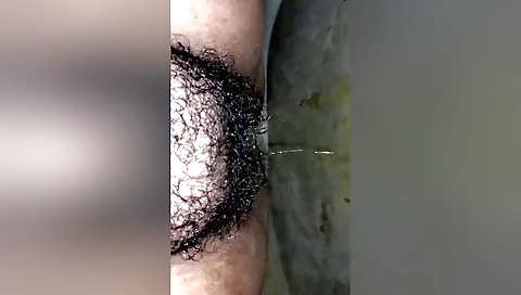 Wimpy hairy pussy pissing and fingering on a towel