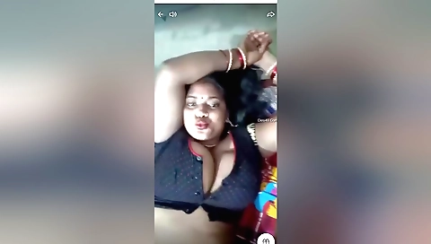 Busty brunette milf in a sexy blouse in front of the camera