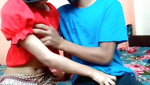 Indian amateur with a shaved pussy is giving a handjob