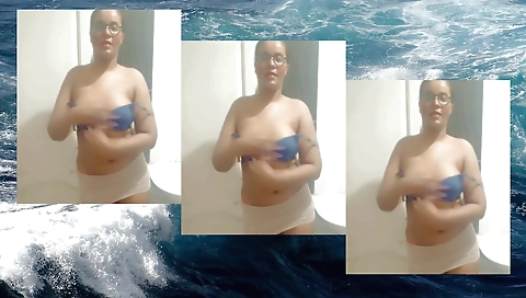 Solo female in a sexy dress with a small ponytail takes photos