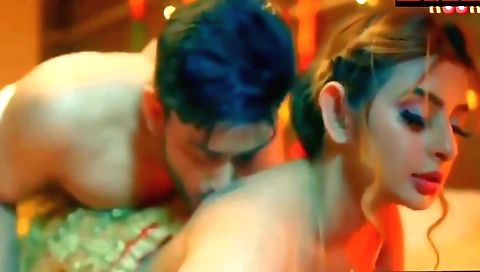 A young woman is in a bikini and her boyfriend is playing