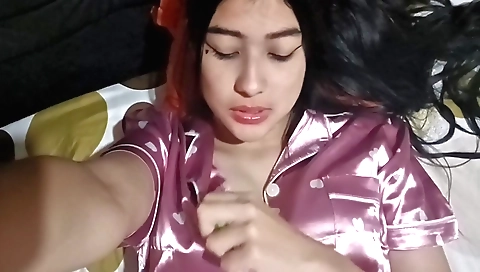 Brunette girl works on her phone with her hands and hair